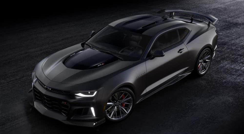 A black 2024 Chevy Camaro ZL1 is shown parked on a dark surface.