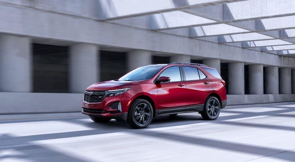 A red 2021 Chevy Equinox RS is shown from the side on the highway.